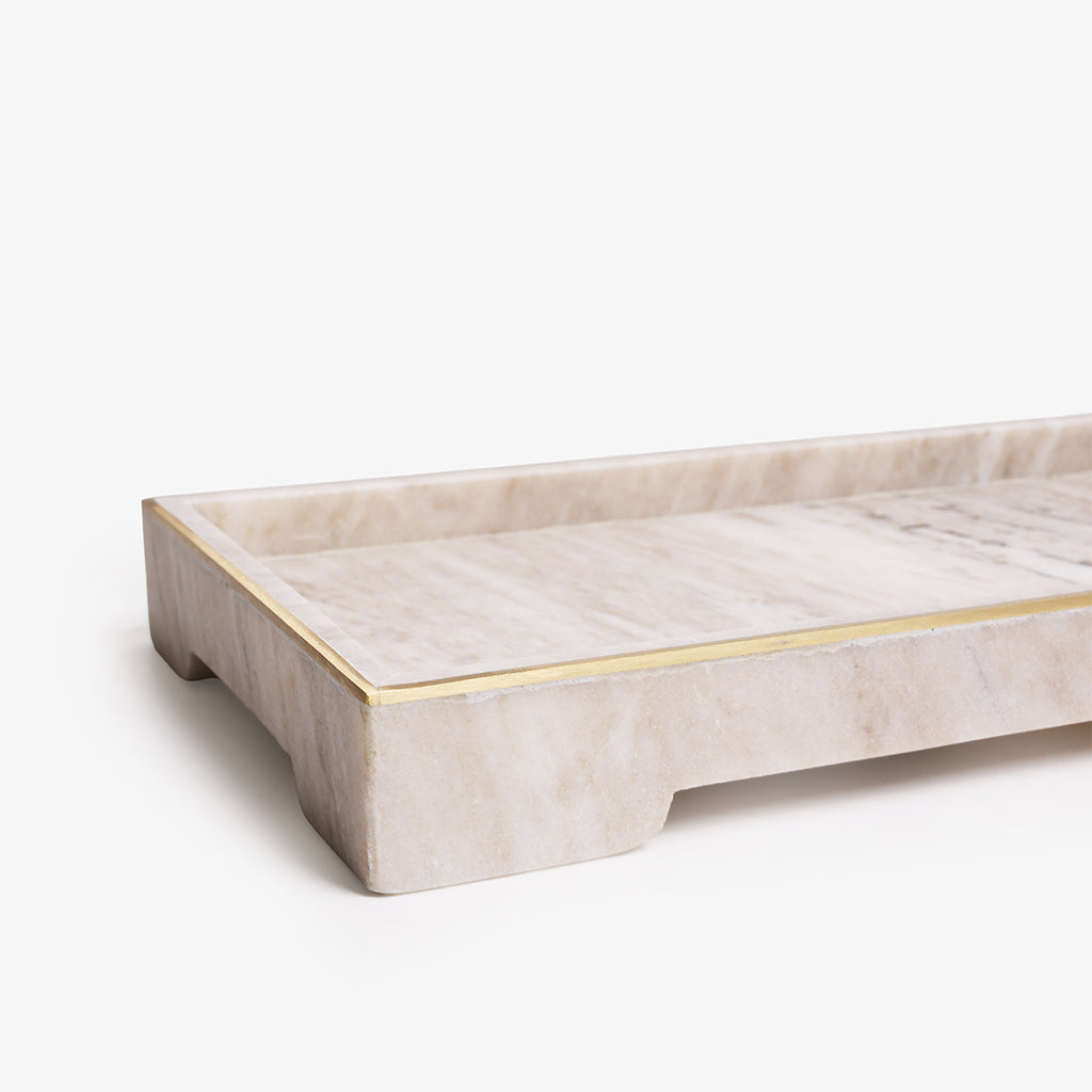 A rectangular marble serving tray with a warm beige and cream marbled surface and a thin gold metal trim along the raised edge, shown on a clean white background.
