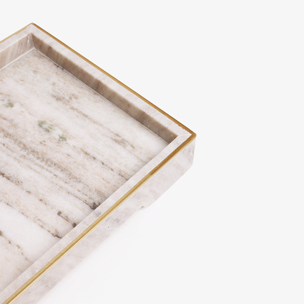A close-up of a rectangular marble tray with a white and beige veined surface and a polished gold metal rim, shown on a clean white background.