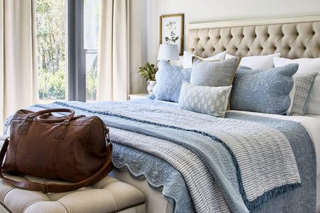 Bed quilt in tones of blue and white.