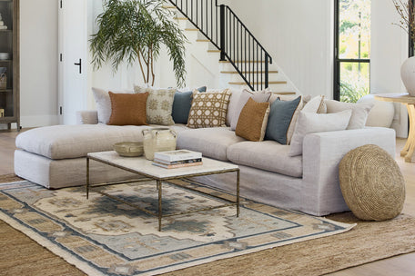 Clara modular lounge in linen with marble coffee table.