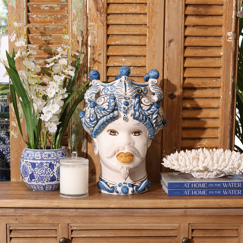 Male Moro Head Statue Styled on Wooden Table with Candle and Orchid