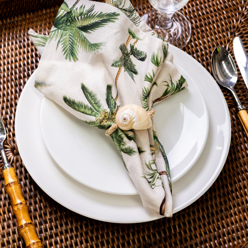 Shell Napkin Rings With Rope Set Of Four (Natural) Styled on Rattan with Palm Tree Napkin