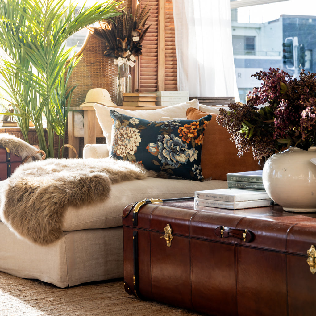 Night Garden Rectangular Cushion Cover Styled on Sofa with Sheepskin Rug and Cognac Leather Coffee Trunk