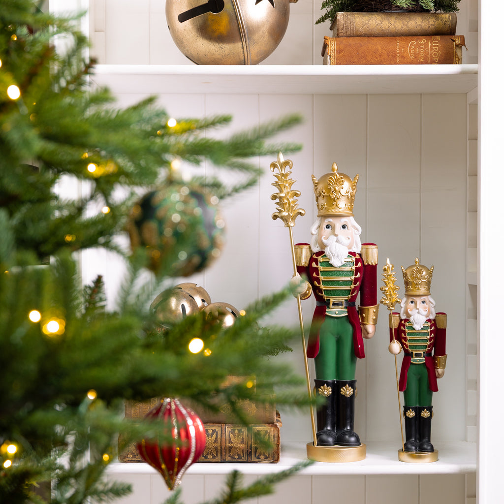 Nutcracker With Staff Ornaments Styled on Bookcase