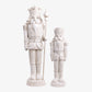 Two white nutcracker figurines on a white background