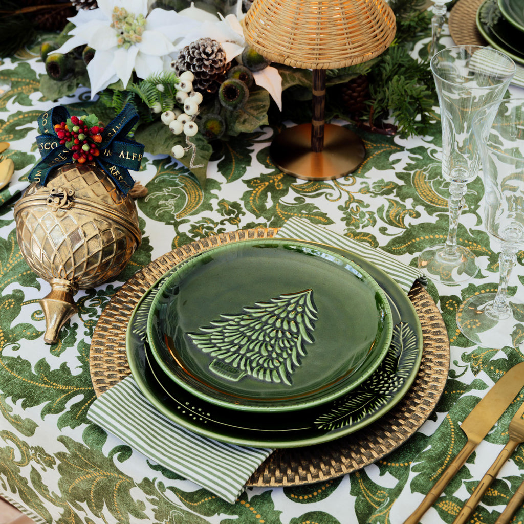 Pinecone & Christmas Tree Green Dinnerware styled on table with batik green tablecloth.