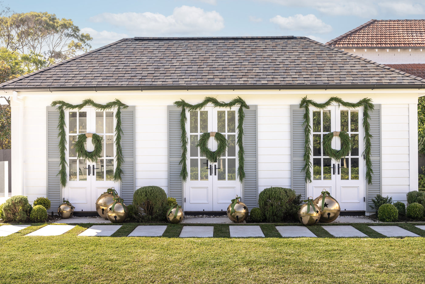 Poolhouse with wreaths, garlands & giant gold star bells.