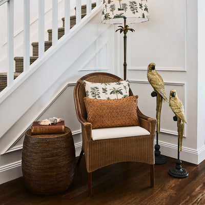 Rattan Drum Stool Brown Styled Next To Rattan Chair