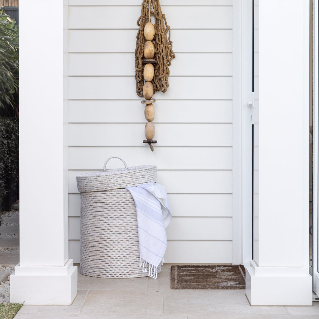 Rattan Laundry Hamper Round White Styled Outside with Towel