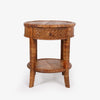 A round rattan side table with a single drawer and two lower legs, featuring a woven rattan top, drawer front, and lower shelf, photographed on a light gray background.