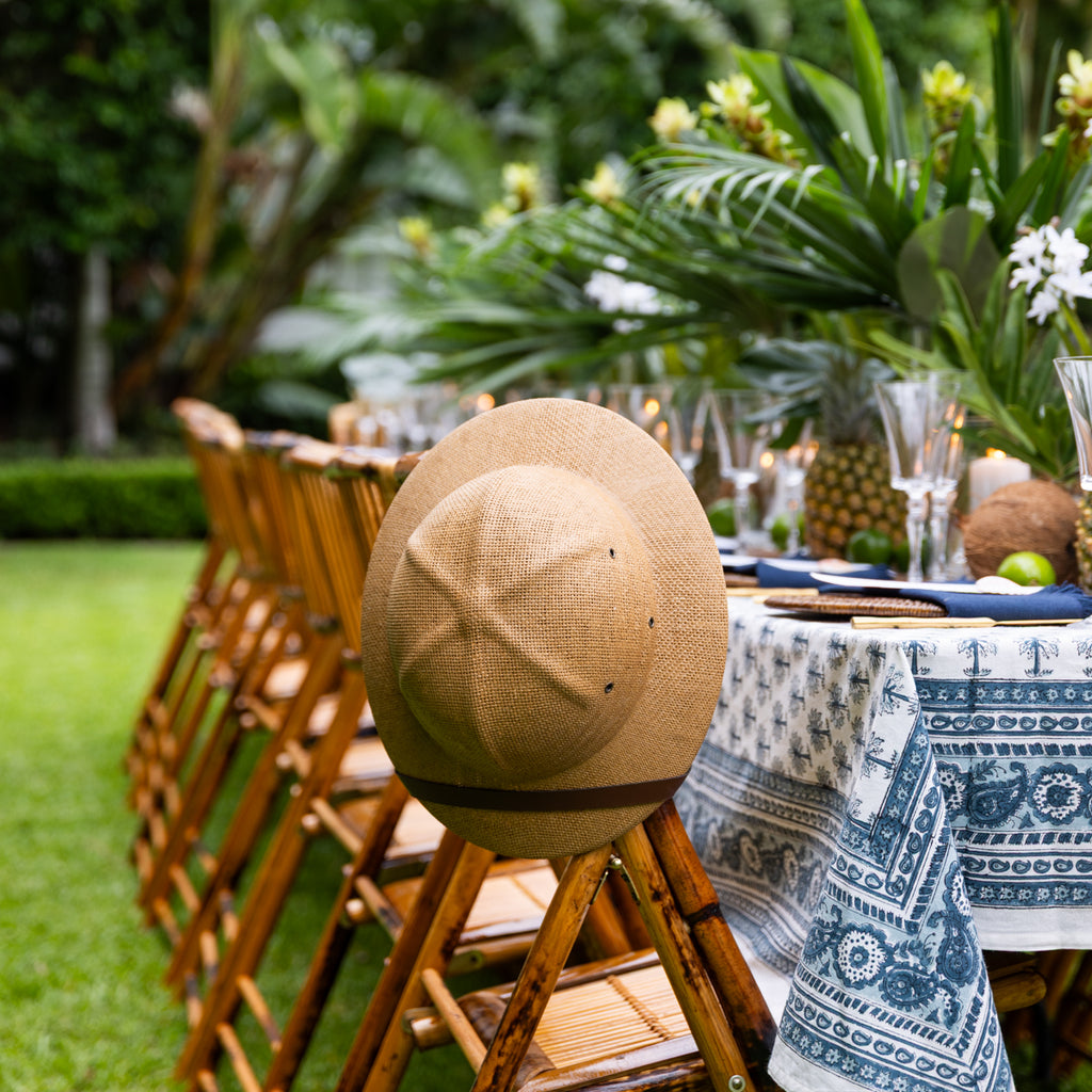 Safari Hat (Dark) Styled on Chair Outside at Dining Table