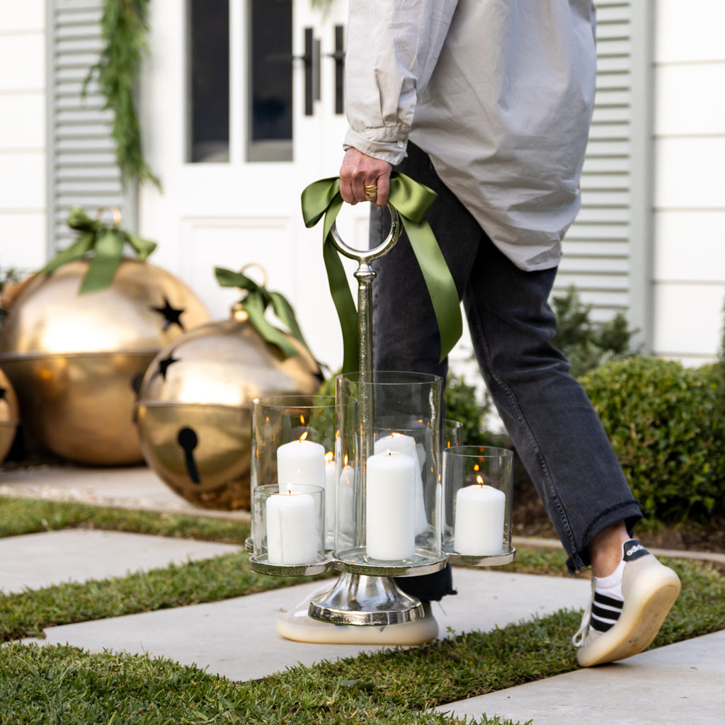 Six Arm Candelabra Candle Holder (Silver) Being Carried and Swinging by Poolhouse