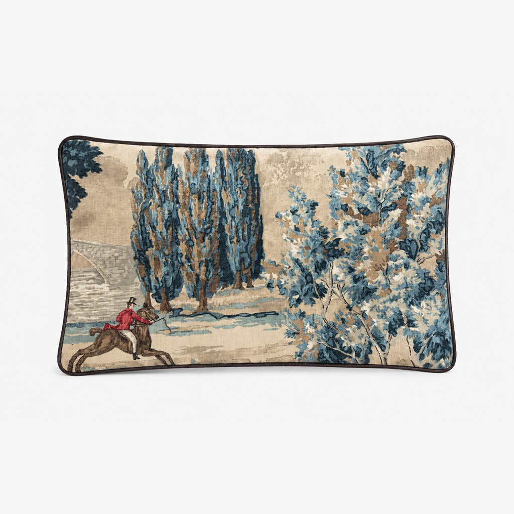Decorative pillow with a landscape design featuring a person on horseback and trees.