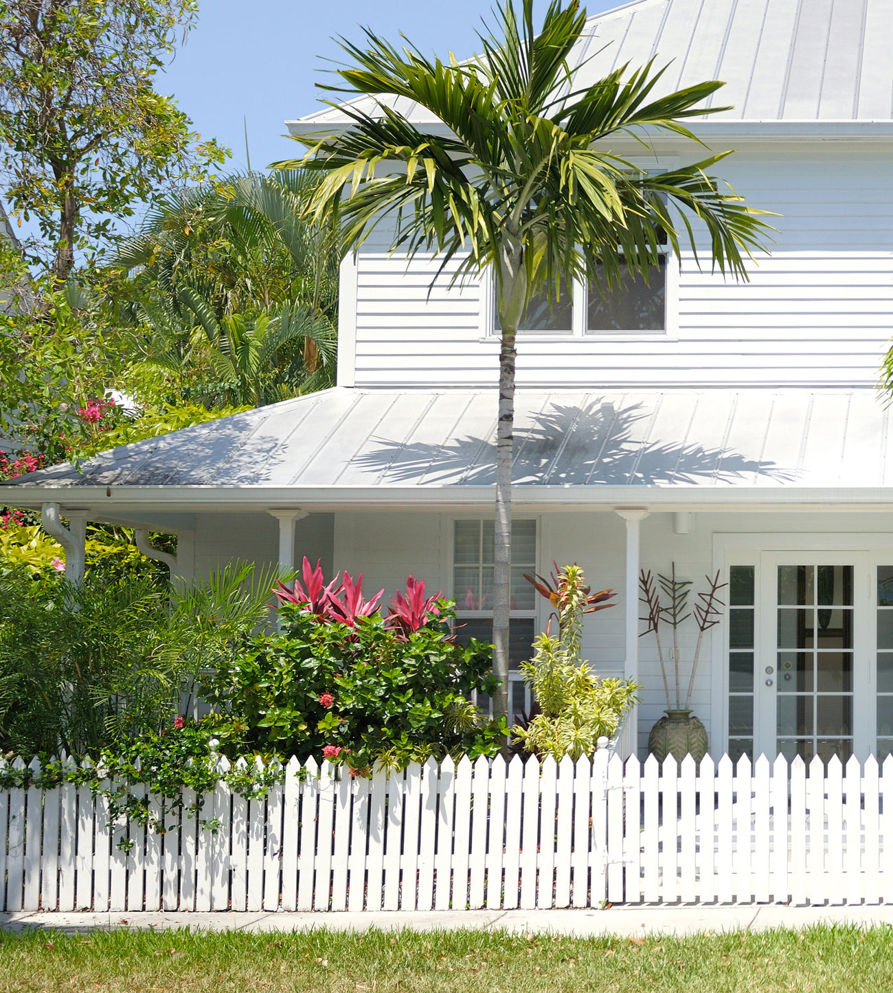 White house surrounded by tropical garden. 