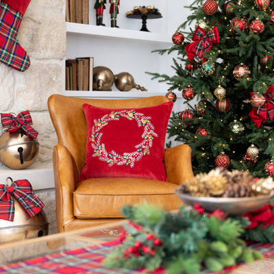 Wreath Velvet Cushion Cover (Red) Styled on Leather Armchair with Christmas Tree Behind