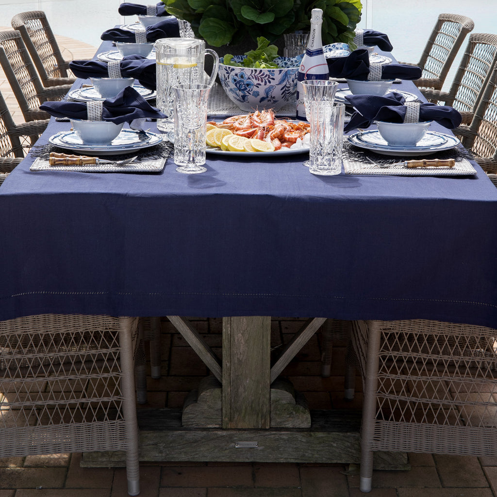 Hampton outdoor dining chairs around rectangular dining table with blue table cloth