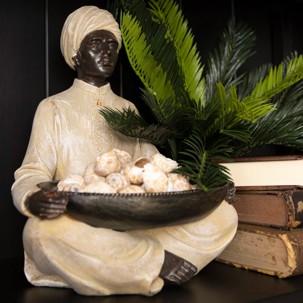 Man Holding Bowl Styled On Black Bookcase